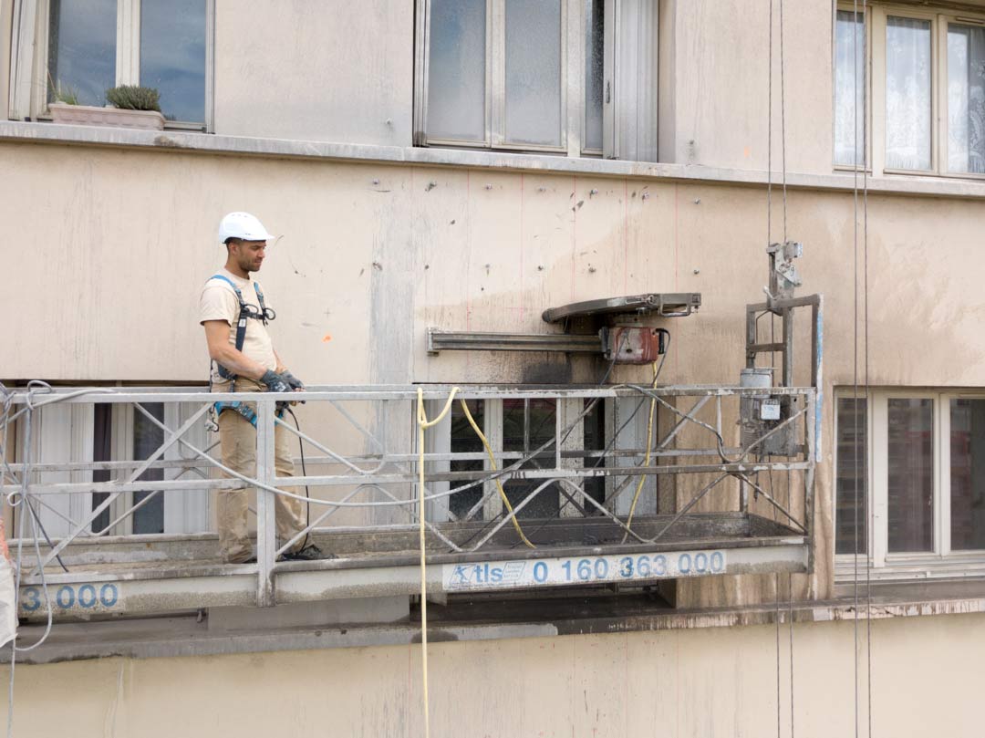 Scie télécommandée en cours de découpe d'une allège en béton